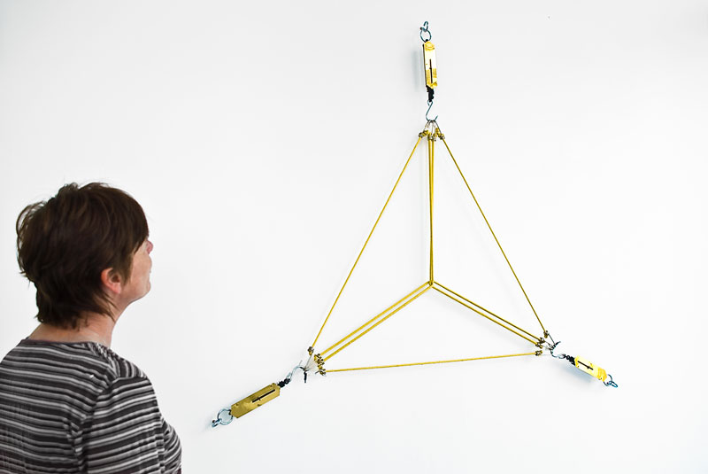 Vista da obra 16kg de Triângulo (2012) na exposição Matter com obras instaladas explorando geometria e medida na MK Gallery.