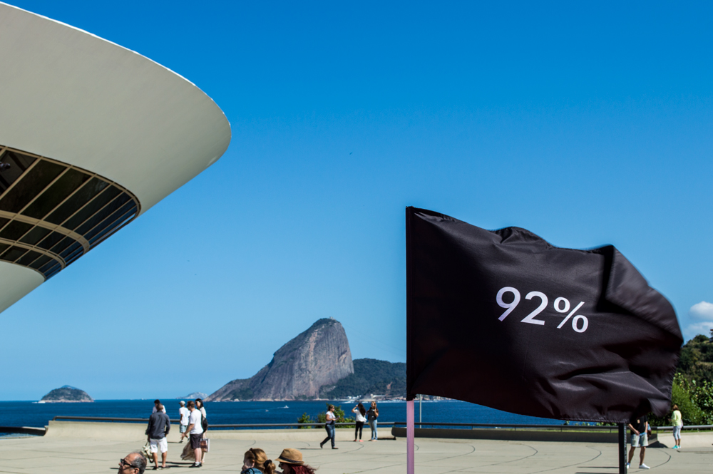 Instalação Progressão de Felippe Moraes com 26 bandeiras em progressão tonal na rampa do MAC Niterói