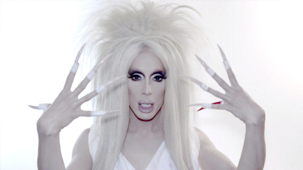 (2017) apresenta a performer Alaska Thunderfuck recitando os primeiros dígitos do número irracional conhecido como phi (1,618...). Historicamente associado a ideias de harmonia e perfeição formal na tradição estética ocidental, esse valor matemático surge no vídeo como matéria vocal e performática. Ao enunciar uma sequência potencialmente infinita, o trabalho transforma um conceito abstrato em gesto corporal e sonoro.
